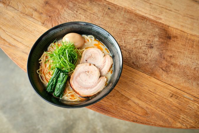 Appetizing traditional Japanese soup with noodles served on table