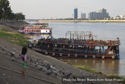 Phnom Penh, Cambodia - Nov 18, 2019: A little girl watches the boats at Tonle Sap River 0KpqY5
