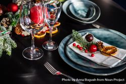 Blue holiday table setting with decorative berries and dried orange slice 4jyaR5