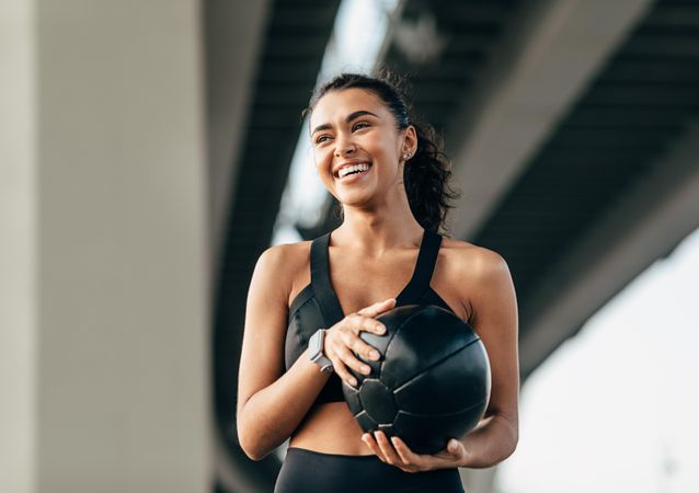 Smiling relaxed woman working out outside