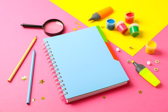 Composition with school supplies on two tone background, space for text