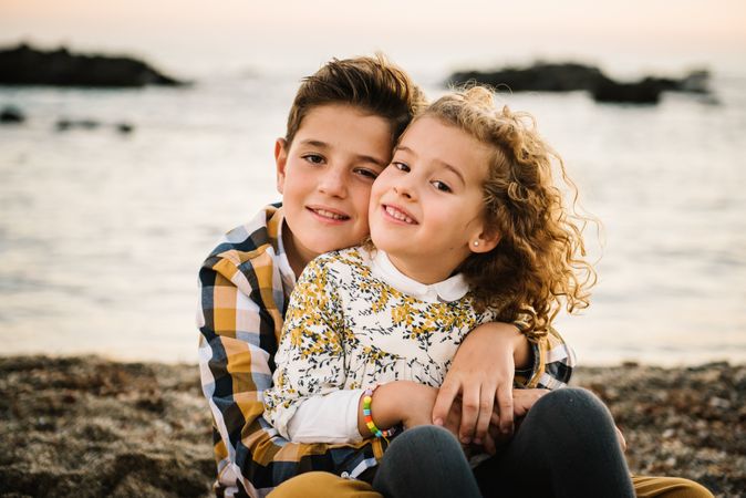 Cute boy and girl hugging each other at beach