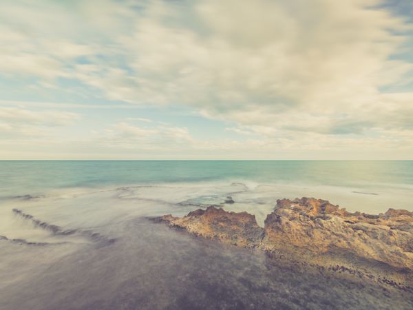 Rocky seashore under blue sky