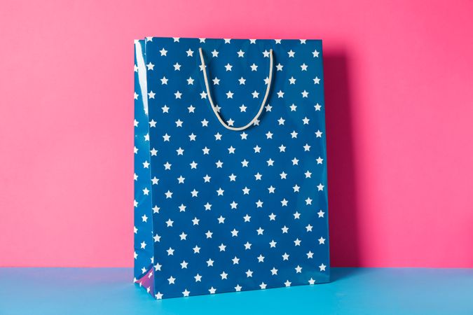 GIft bag on multicolor background, space for text