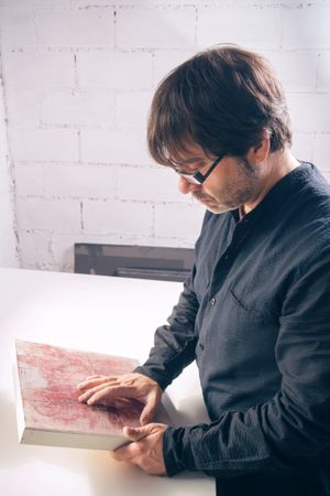 Painter artist reviewing his finished modern artwork