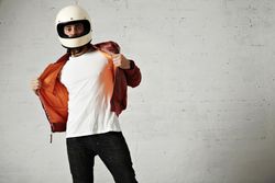 Man in open dark red leather jacket and biker helmet