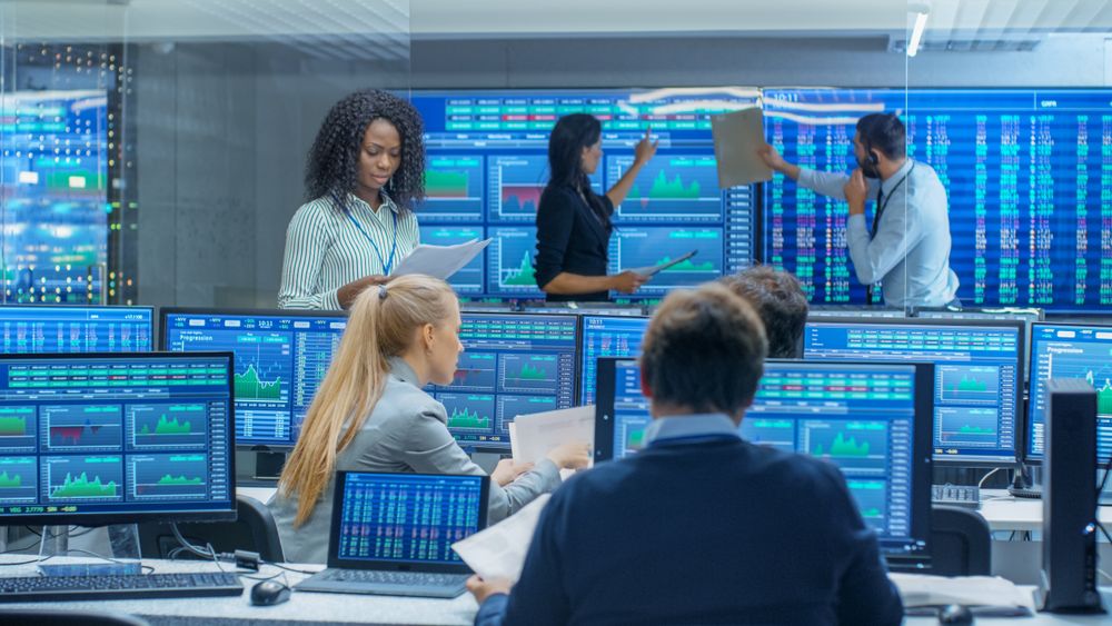 Multi-Ethnic Team of Traders is Busy Working at the Stock Exchange Office.