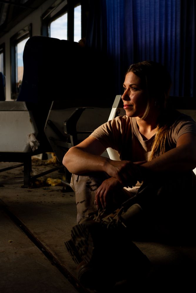 Female soldier on floor of military vehicle