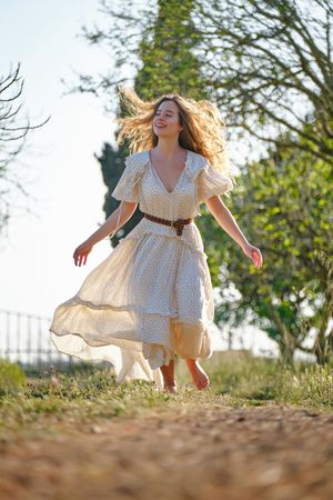 Optimistic female walking in garden