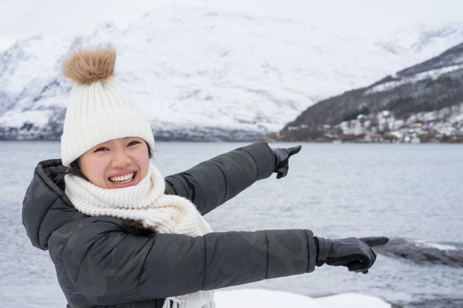 Joyful young woman in warm clothes