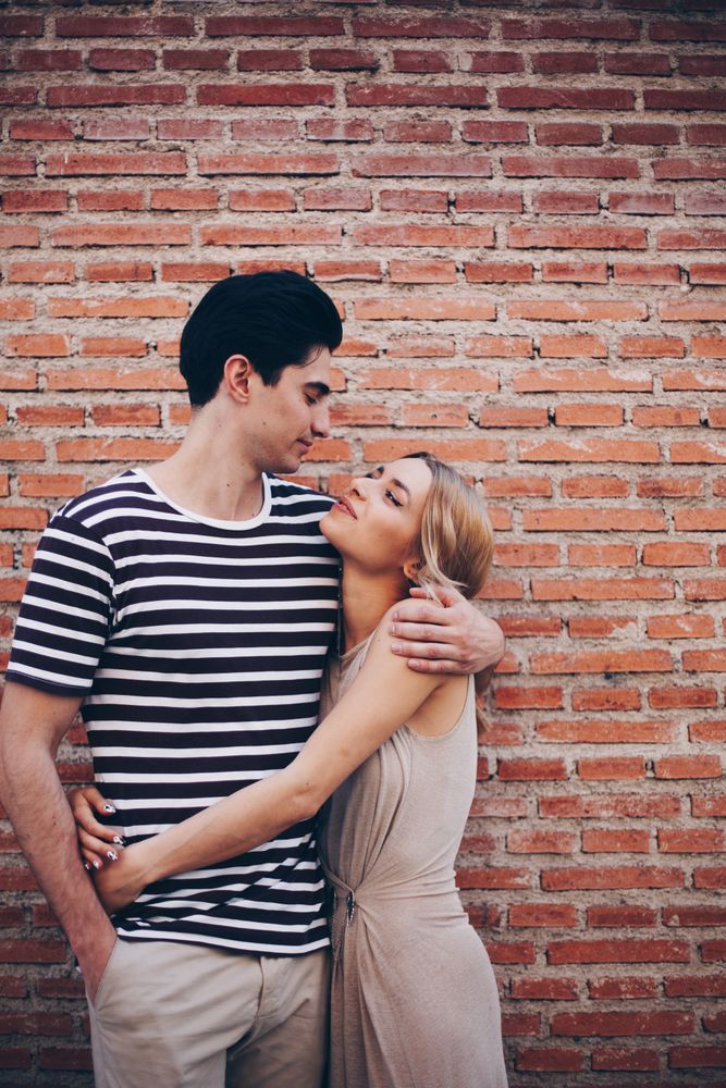 Happy couple having fun and embracing in the street