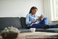 Happy woman lounging with tablet bYmD1b