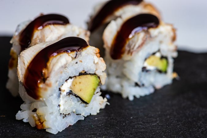 Sushi rolls with crab, avocado, eel sauce and cream cheese with copy space