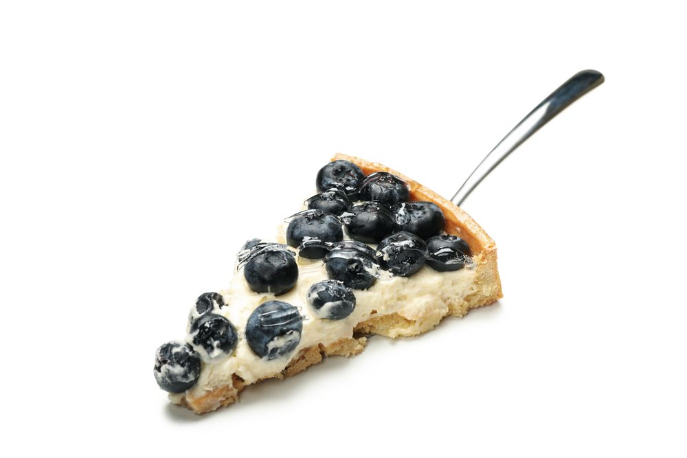 Spatula with blueberry pie slice isolated on light background