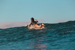 woman on surf board floating on water