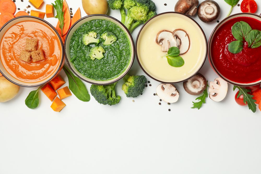 Colorful autumn soups arranged on top of picture with copy space