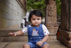 Girl in denim overhaul sitting in concrete stairs outdoor