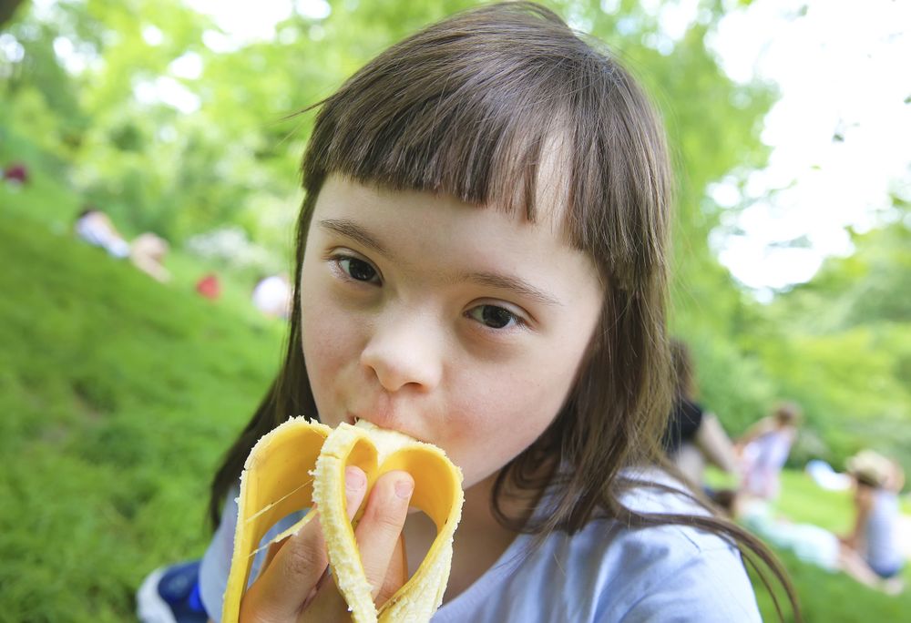 Close up of young female eating a banana