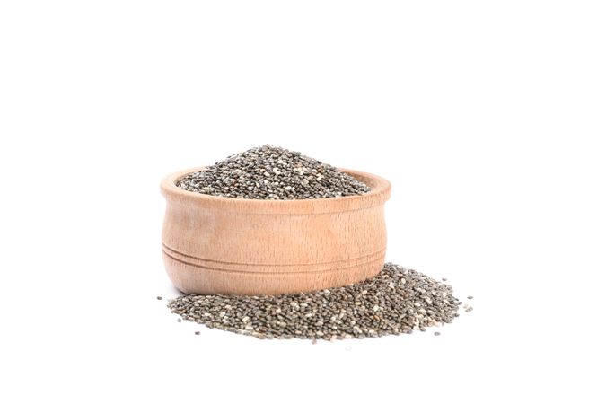 Chia seeds and wooden bowl isolated on plain background