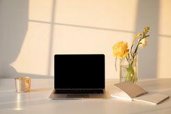 Laptop next to Notebook with sparkling light