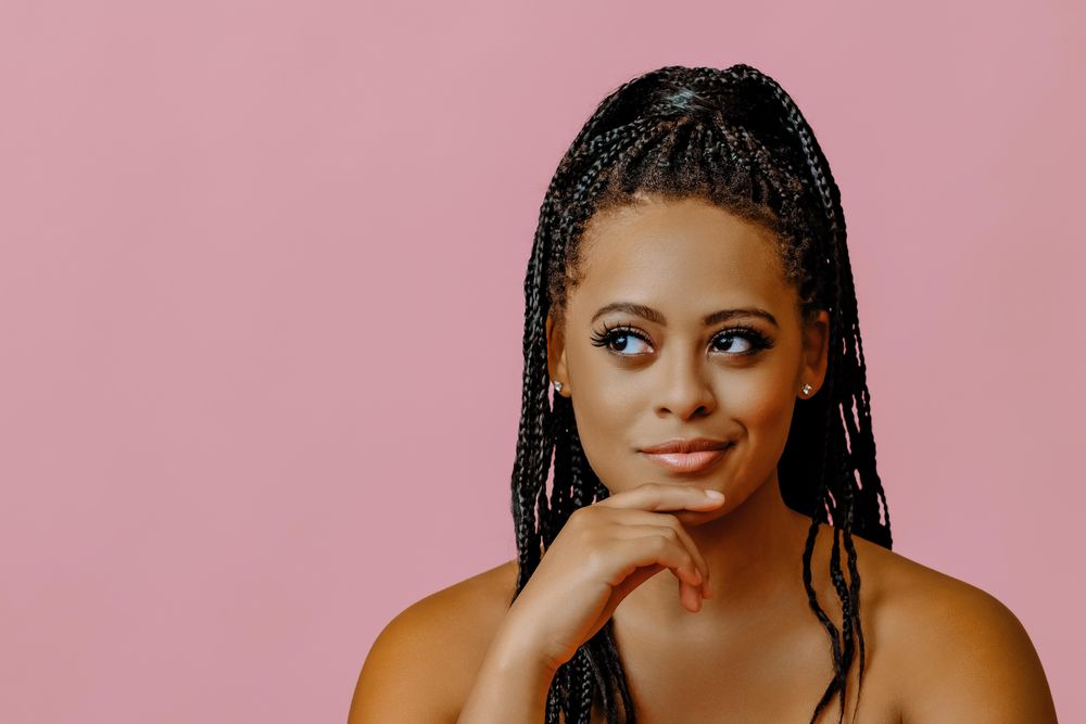 Serious female looking at copy space in pink studio shoot