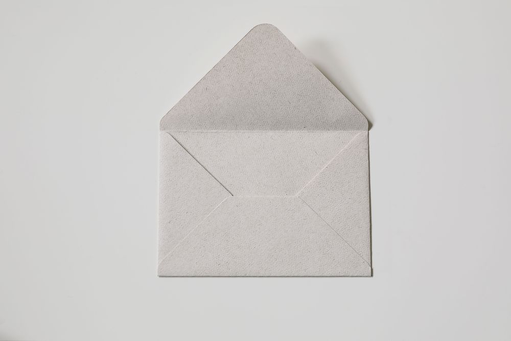 Close-up neutral textured paper envelope on beige background