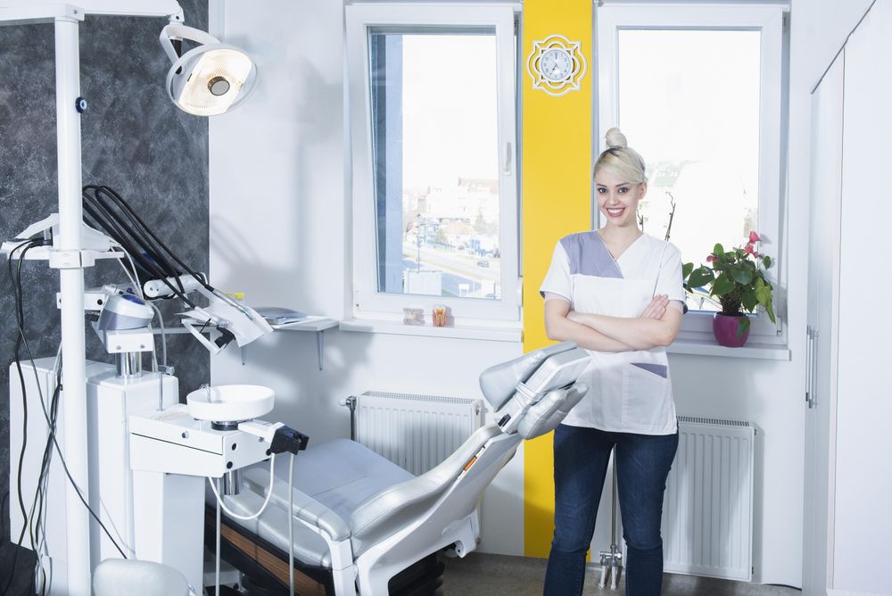 Smiling blond dentist in her bright office