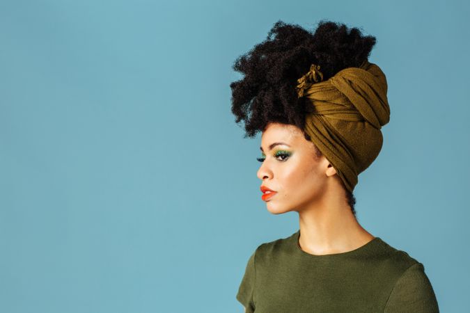 Studio shoot of Black woman wearing a green hair scarf