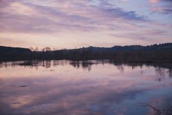Cloudy evening sky over calm lake