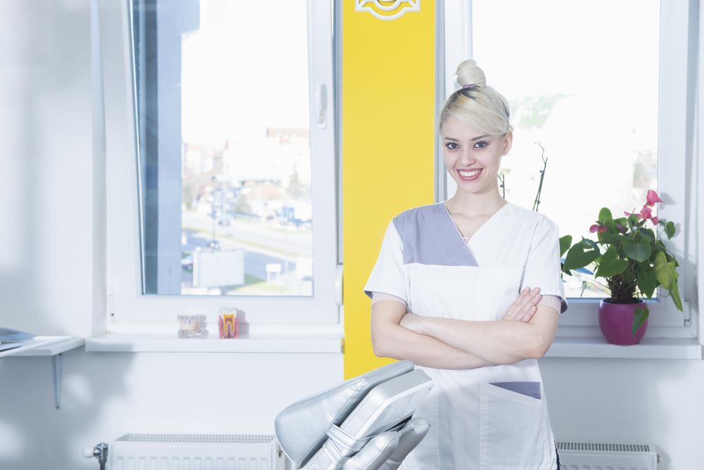 Happy female dentist in her office