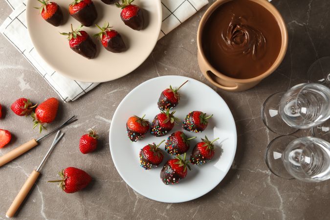 Composition with chocolate fondue on gray table. Delicious sweet food