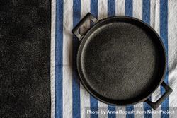 Empty pan on striped napkin as a table setting concept 4MG6Qa