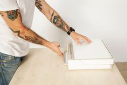 Man closing printer in bright home office