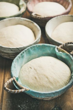 Multiple baskets of bread dough