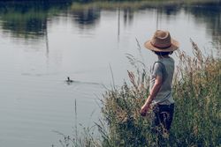 Anonymous boy admiring river view