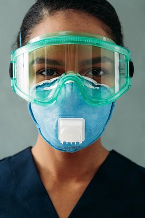 Female Black doctor’s face in PPE gear