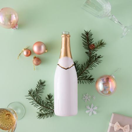 Top view of wine glasses, Christmas decorations and champagne bottle and tree branch