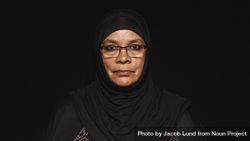Close up of a muslim woman in hijab isolated on dark background 4826J0