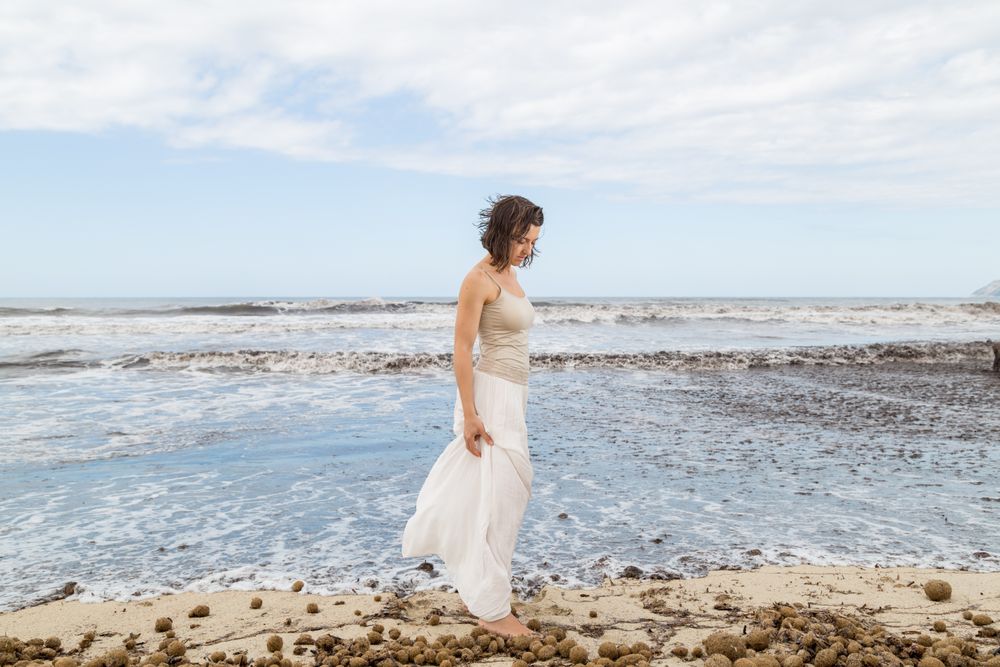 Charming young woman on shore near water