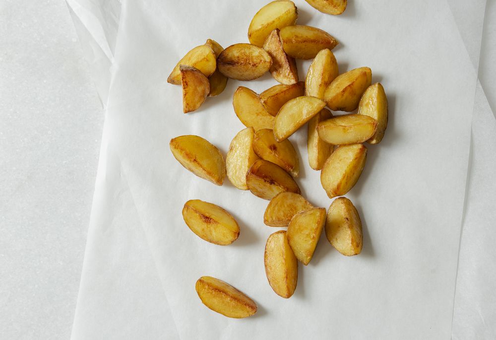 Potato wedges on light background