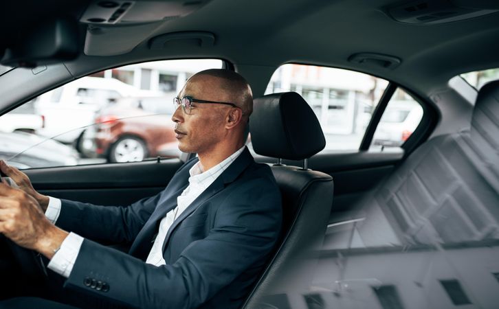 Man in smart clothes sitting in the driving seat going to office