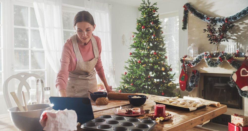Portrait of a Woman Using Digital Tablet to Follow an Online Recipe While Cooking Dinner for Christmas Eve.