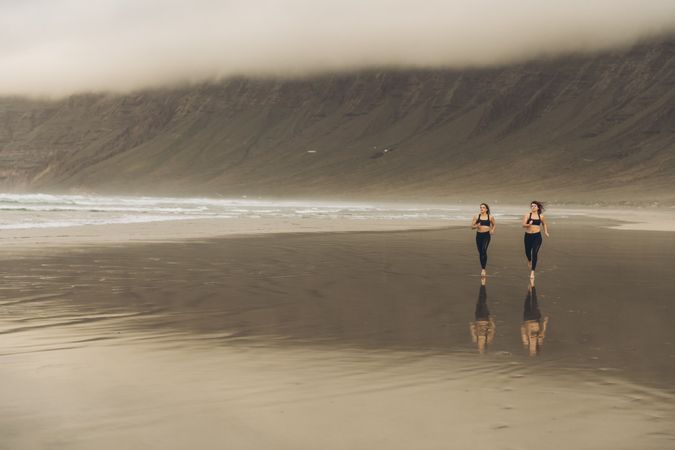 Anonymous women running near sea