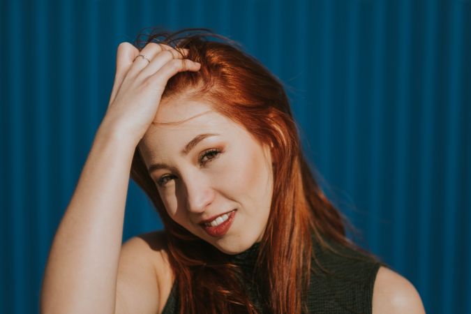 Smiling woman squinting in sun and enjoying weather