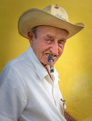 Havana, Cuba - November, 22 2012: Older man smoking cigar on street