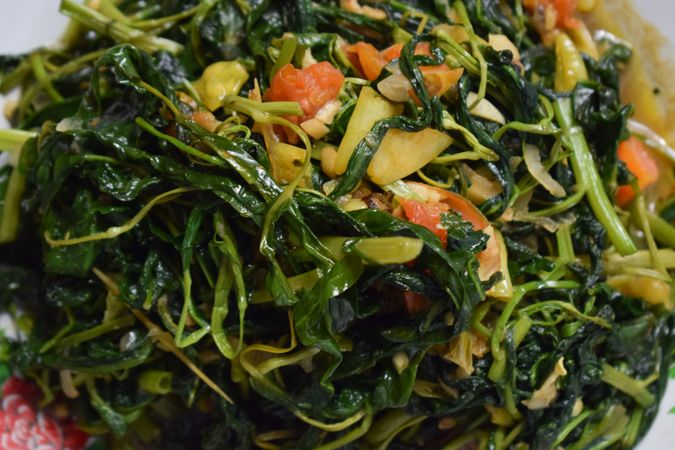 Top view of plate of Indonesian spinach side dish