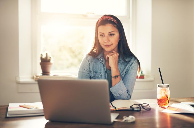 Woman working on laptop in home office