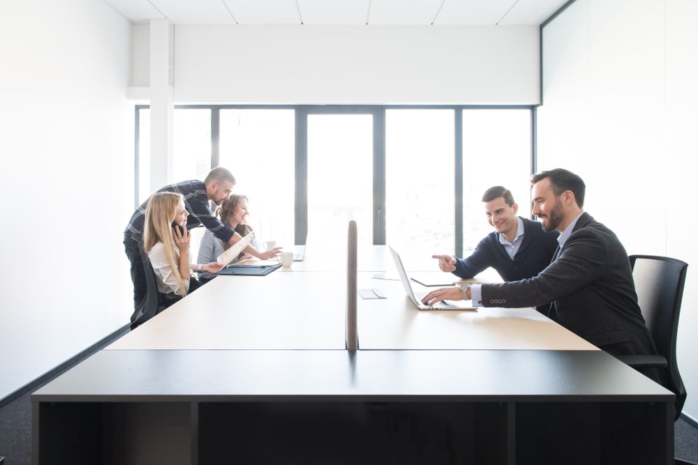 Smiling coworkers in teams inside of office