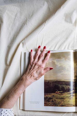 Older woman's hand on an open magazine