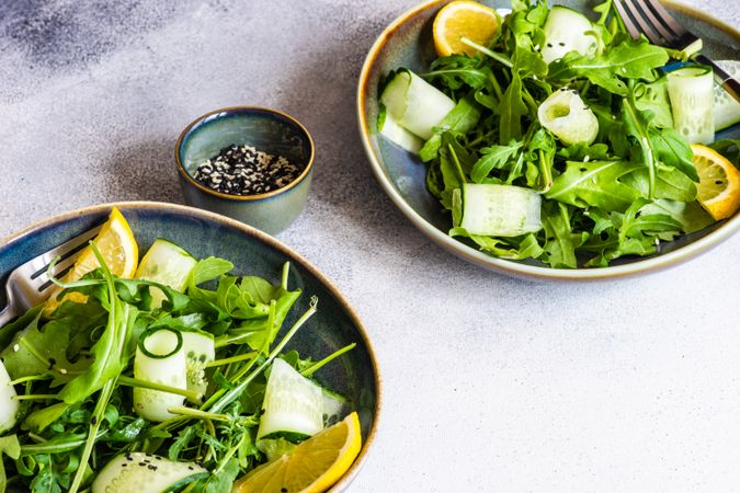 Two healthy vegetable salad with arugula and avocado